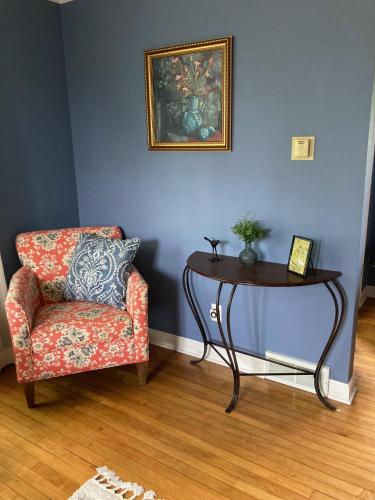 a table and a chair in a living room at Cozy Algoma Retreat! Minutes to Beach and Downtown! in Algoma