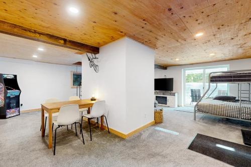 a room with a table and chairs and a bed at Alpine Modern A-Frame in Snoqualmie Pass