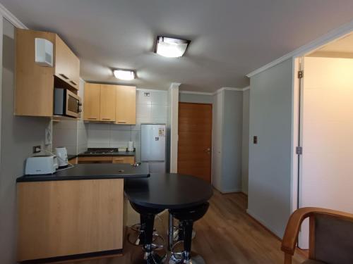 a kitchen with a table and a counter top at APART LOMAS DE SAN ANDRES concepción in Concepción