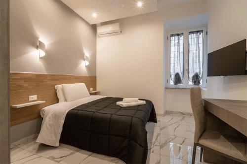 a hotel room with a bed and a television at TERMINI HOLIDAY in Rome
