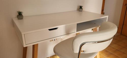 a white desk and a white chair in a room at Casa Estulio in Pontey