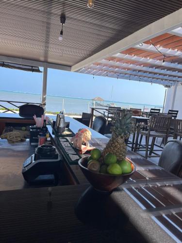 a bowl of fruit sitting on a table with the ocean in the background at Captain Morgan's Retreat in San Pedro