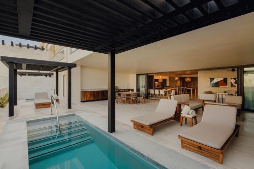a house with a swimming pool and a patio at Nobu Hotel Los Cabos in Cabo San Lucas