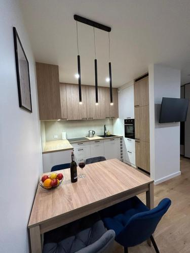 eine Küche mit einem Tisch und einer Obstschale darauf in der Unterkunft Apartament Klonova dla dorosłych in Olecko
