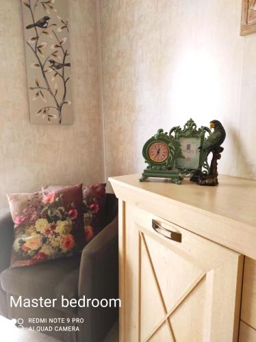a clock sitting on top of a dresser in a room at "Spirit of Malta" Historic Maltese Townhouse by the sea in Sliema