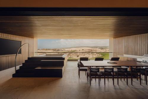 a kitchen and dining room with a table and chairs at Nobu Hotel Los Cabos in Cabo San Lucas