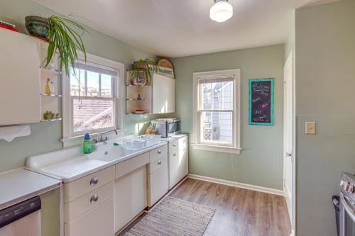 a kitchen with a sink and two windows at Billings Vacation Rental about 1 Mi to Downtown! in Billings