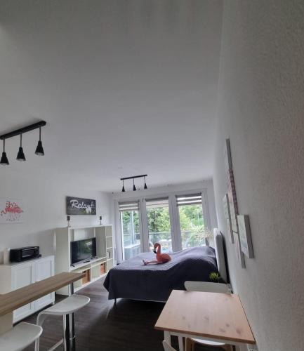 a bedroom with a bed and a desk and a table at Ferienwohnung Köln in Cologne