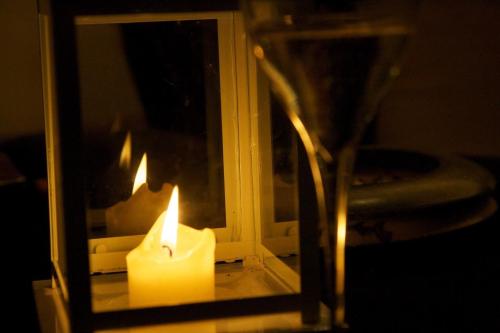 a candle and a vase with a mirror at La Bussola Da Gino in Quarrata