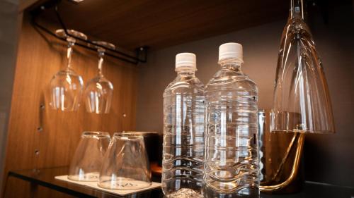 a group of bottles and glasses on a table at サンメール座間味 in Zamami
