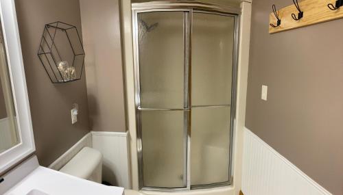 a bathroom with a shower and a toilet in it at Cozy Algoma Retreat! Minutes to Beach and Downtown! in Algoma