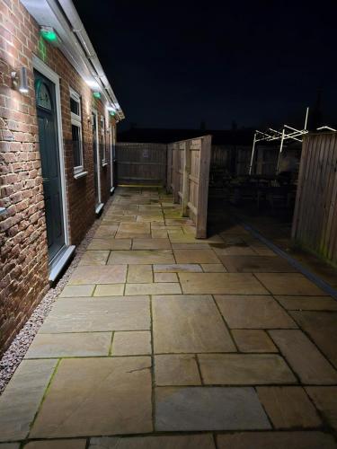 an empty alley with a brick building at night at The Woodmans Cottage in Gorfield