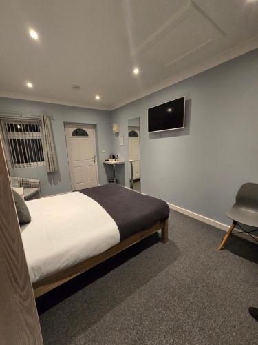 a bedroom with a bed and a tv on the wall at The Woodmans Cottage in Gorfield