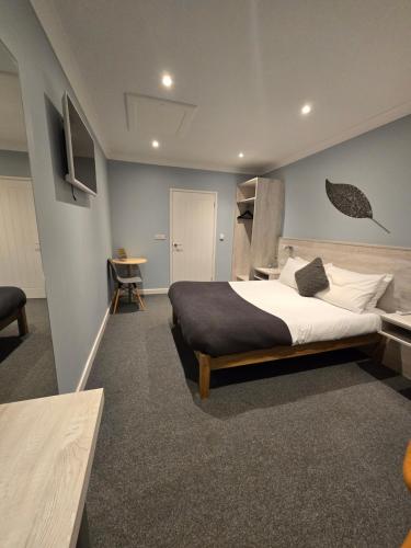 a bedroom with a large bed and a desk at The Woodmans Cottage in Gorfield