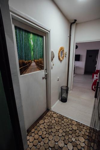 a door leading to a room with a door at Nara Apartment in Valjevo