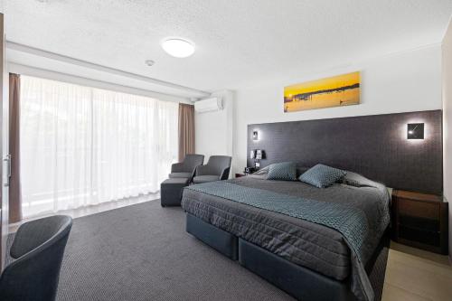 Ένα ή περισσότερα κρεβάτια σε δωμάτιο στο El Motor Inn