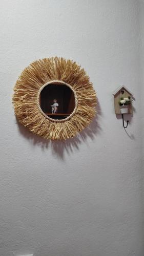 a gold mirror on a wall with a person in it at Nara Apartment in Valjevo