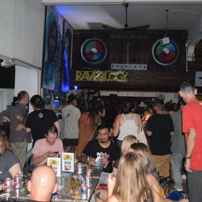 a group of people sitting around a bar in a party at The Eighty8 PP in Phnom Penh