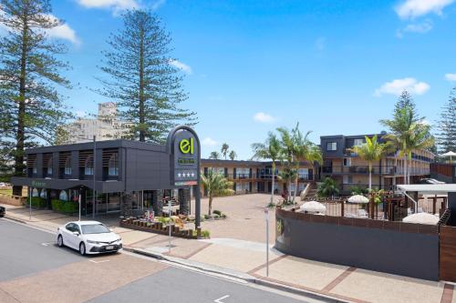 a car parked in a parking lot in front of a building at El Motor Inn in Port Macquarie