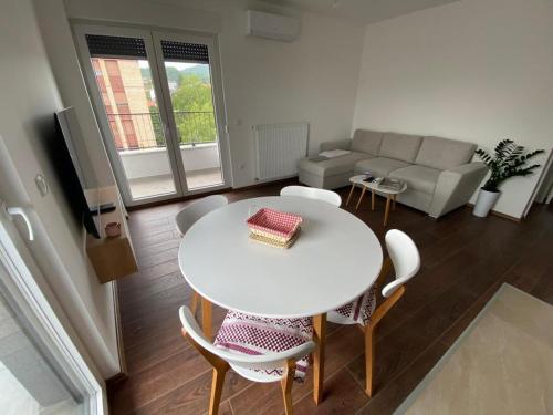 a living room with a white table and chairs at LadyDi apartman in Banja Koviljača