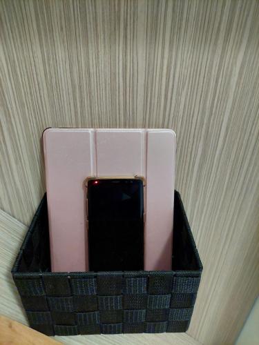 a cell phone in a holder on a wall at Apartma Pikabooth in Topolšica