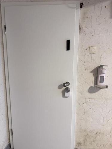a white door in a bathroom with a stone wall at Royal Stay in Olsberg