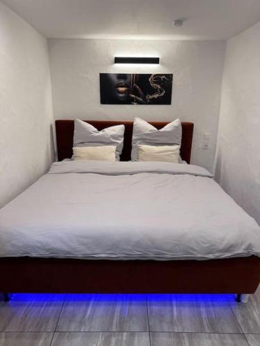 a bedroom with a large bed with white sheets and pillows at Royal Stay in Olsberg