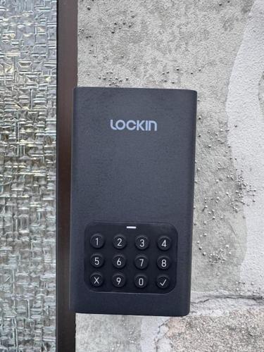 a black remote control sitting on the side of a wall at Royal Stay in Olsberg