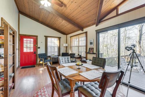 a dining room with a table and a red door at Smoky Mountain Cabin with Fire Pit and Stunning Views! in Andrews