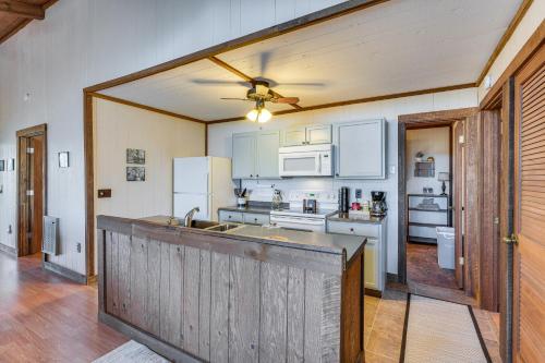 a kitchen with white appliances and a ceiling fan at Smoky Mountain Cabin with Fire Pit and Stunning Views! in Andrews