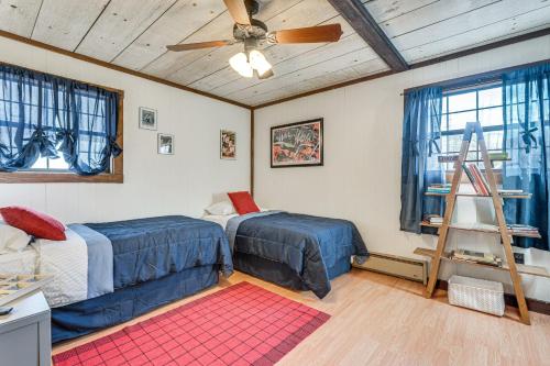 a bedroom with two beds and a ceiling fan at Smoky Mountain Cabin with Fire Pit and Stunning Views! in Andrews
