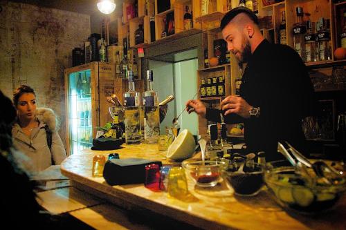 a man standing at a bar preparing a drink at La Bussola Da Gino in Quarrata
