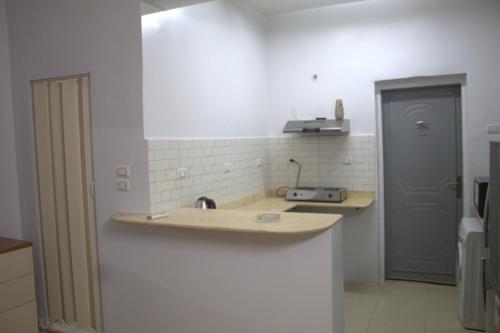 a kitchen with a sink and a counter top at Abeer Guest House in Luxor