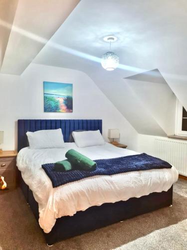 a bedroom with a bed with green pillows on it at 2 Swinton Mill Farm Cottage in Swinton