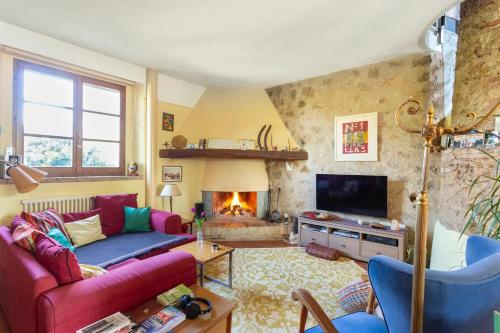 a living room with a couch and a fireplace at Cozy room at Podere Noceto in Grotti