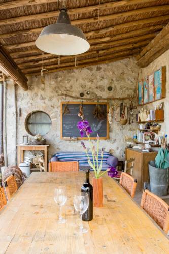 a dining room with a wooden table with wine glasses at Cozy room at Podere Noceto in Grotti