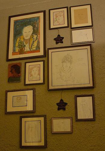 a bunch of framed pictures on a wall at La Bussola Da Gino in Quarrata