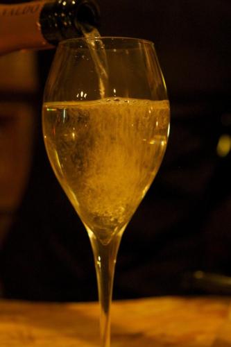 a person is pouring a glass of white wine at La Bussola Da Gino in Quarrata