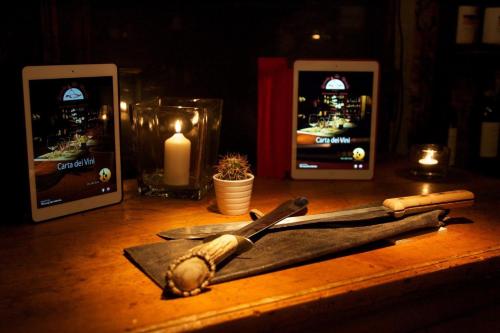 a wooden table with a knife and a candle at La Bussola Da Gino in Quarrata