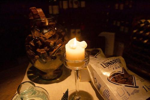 a candle on a table with a candle in a wine glass at La Bussola Da Gino in Quarrata