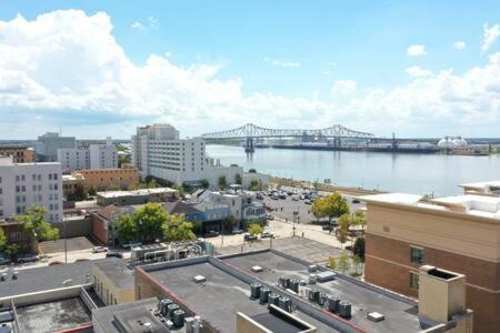 a view of a city with a bridge in the background at The Best of Downtown Living in Baton Rouge