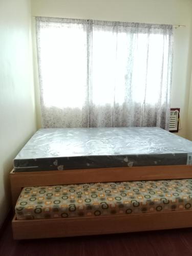 a bed in a room with a window with a mattress at Villa Ceferina in Tagbilaran City