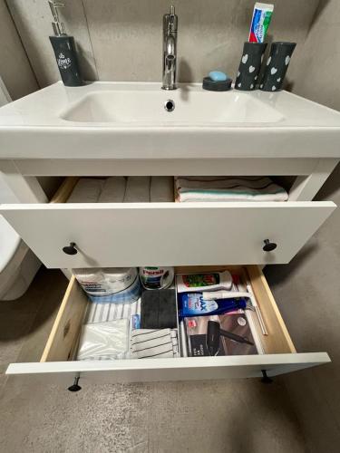 a white bathroom sink with a drawer underneath it at LadyDi apartman in Banja Koviljača