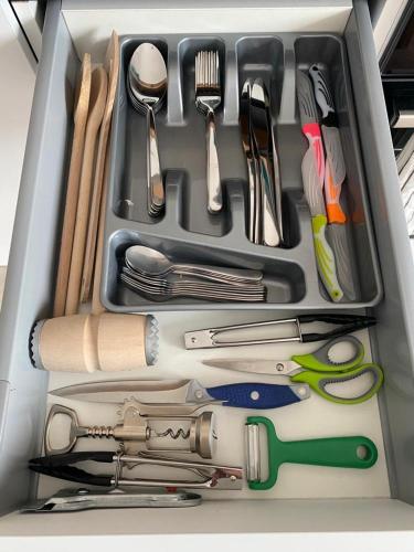 a drawer full of kitchen utensils in a container at LadyDi apartman in Banja Koviljača