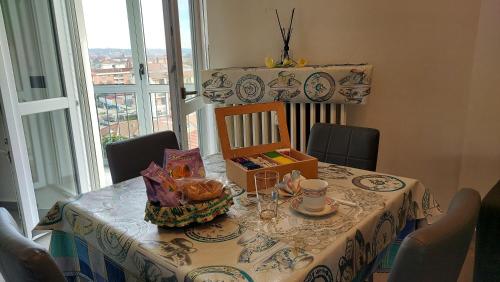 a table with a table cloth on it with a tableablish at Sesto Piano Apartment in Asti