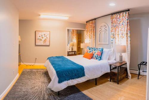 a bedroom with a large bed with a blue blanket at New Beautiful Condo In Bayonne near NYC. in Bayonne