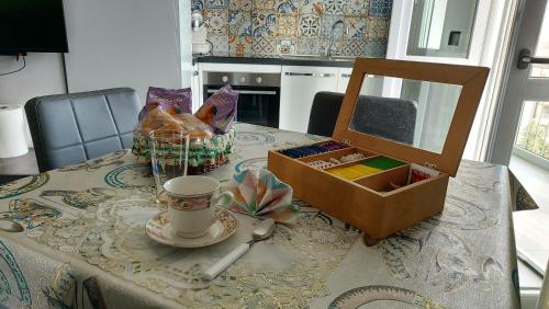 a table with a mirror and a box on it at Sesto Piano Apartment in Asti