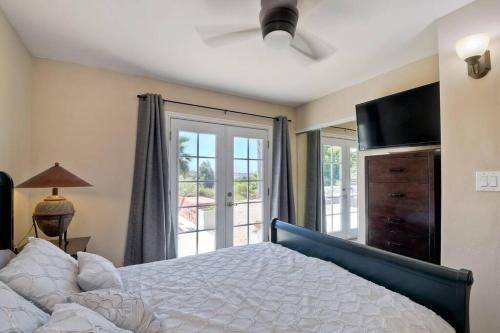 a bedroom with a bed and a sliding glass door at Ocean View Spa Retreat, Hot Tub, Sauna, Close to the beach, 9 sleeps in Oceanside
