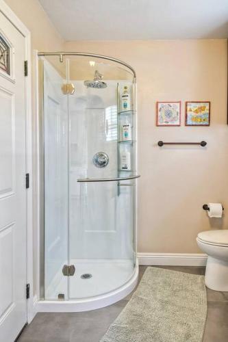 a shower stall in a bathroom with a toilet at Ocean View Spa Retreat, Hot Tub, Sauna, Close to the beach, 9 sleeps in Oceanside