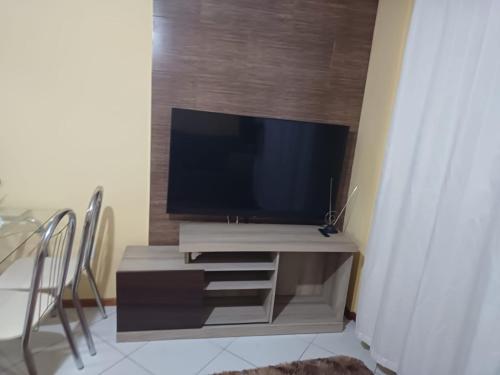 a flat screen tv sitting on a entertainment center at Estadia da Josi in Balneário Camboriú